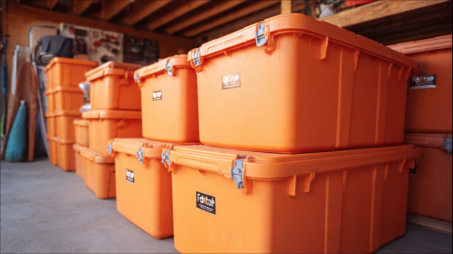 FlashTotes orange moving totes stacked in a garage